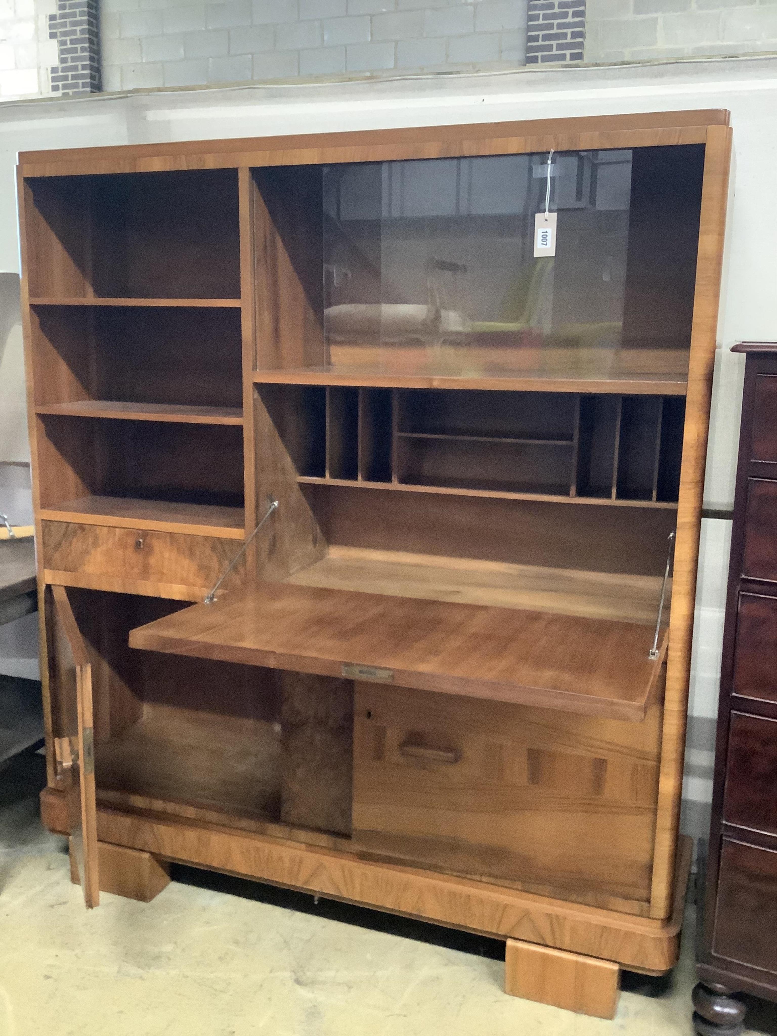An Art Deco German walnut bureau cabinet, width 138cm, depth 37cm, height 160cm